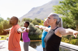Mature group of people doing breathing exercise. Exercise mental health