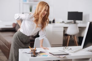 lower back pain treatment | 75238357 - suffering young secretary feeling bad in the office